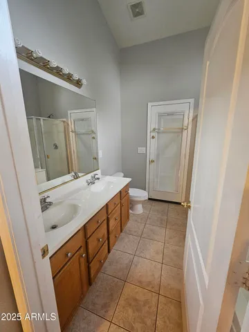 a bathroom with a sink vanity and mirror