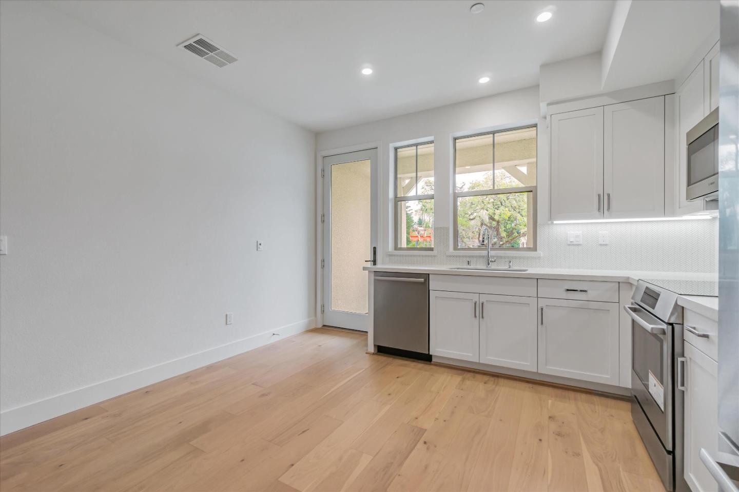 230 Oak Circle Walnut Creek, CA 94597 - Photo 8 of 22 a view of an empty room with a window and wooden floor
