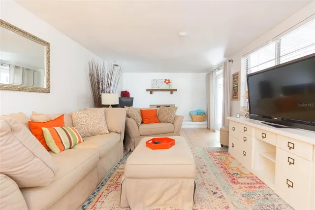a bedroom with a bed and a flat tv screen on dresser