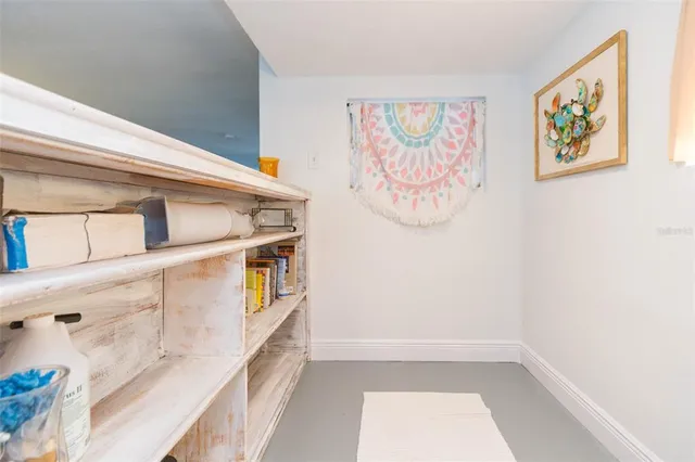 a living room with fireplace furniture and a large window