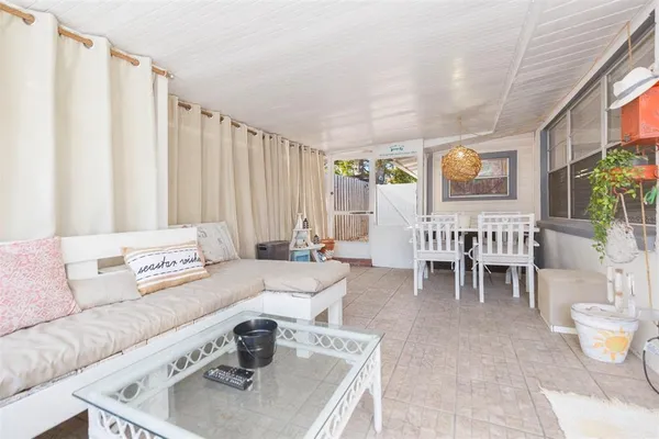 a view of a chairs and table in backyard