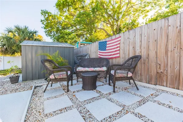 a view of a chairs and table in backyard