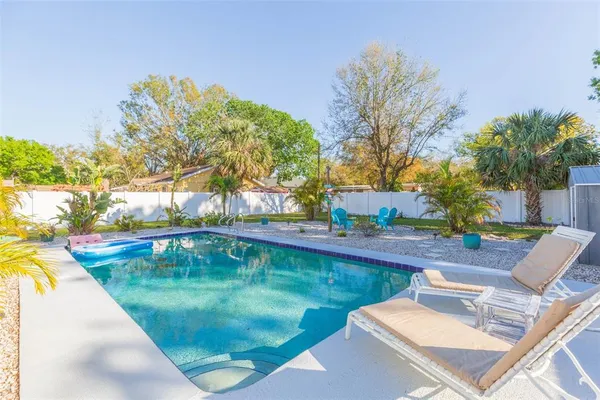 a view of a chair and table in backyard