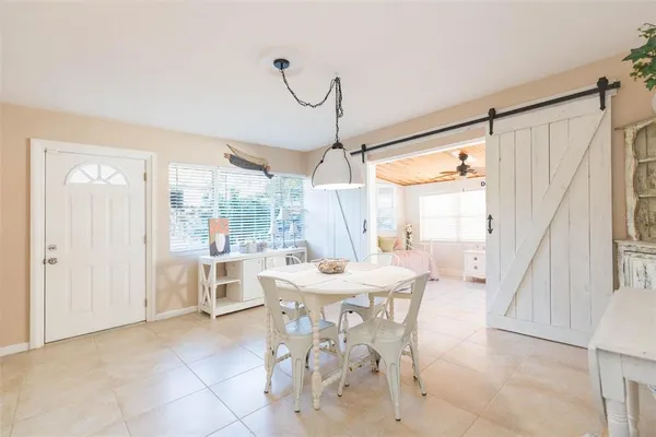 a dining room with furniture a chandelier and a rug
