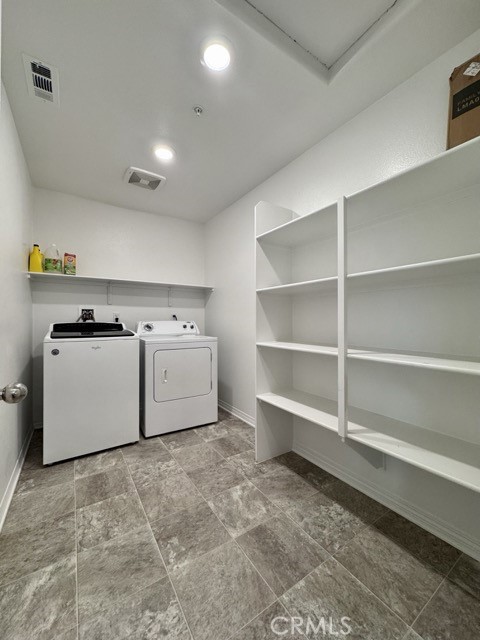 30115 Adrift Lane Menifee, CA 92584 - Photo 29 of 60 a utility room with cabinets washer and dryer
