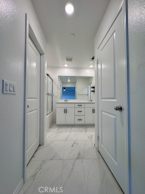 30115 Adrift Lane Menifee, CA 92584 - Photo 31 of 60 a bathroom with a mirror and a shower