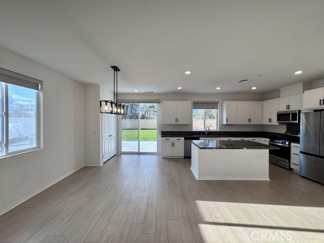 30115 Adrift Lane Menifee, CA 92584 - Photo 9 of 60 a kitchen with a refrigerator and a wooden floor