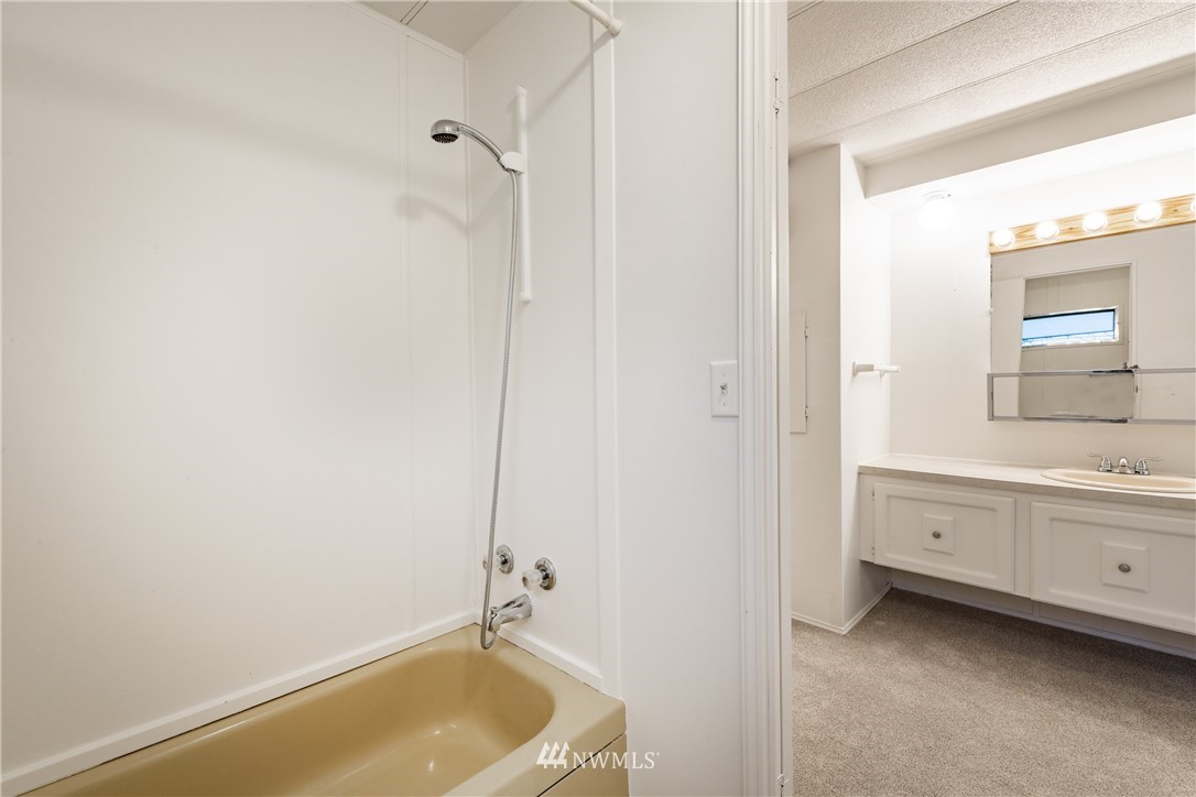3177 Creasey Road Custer, WA 98240 - Photo 18 of 38 a bathroom with a tub sink and mirror