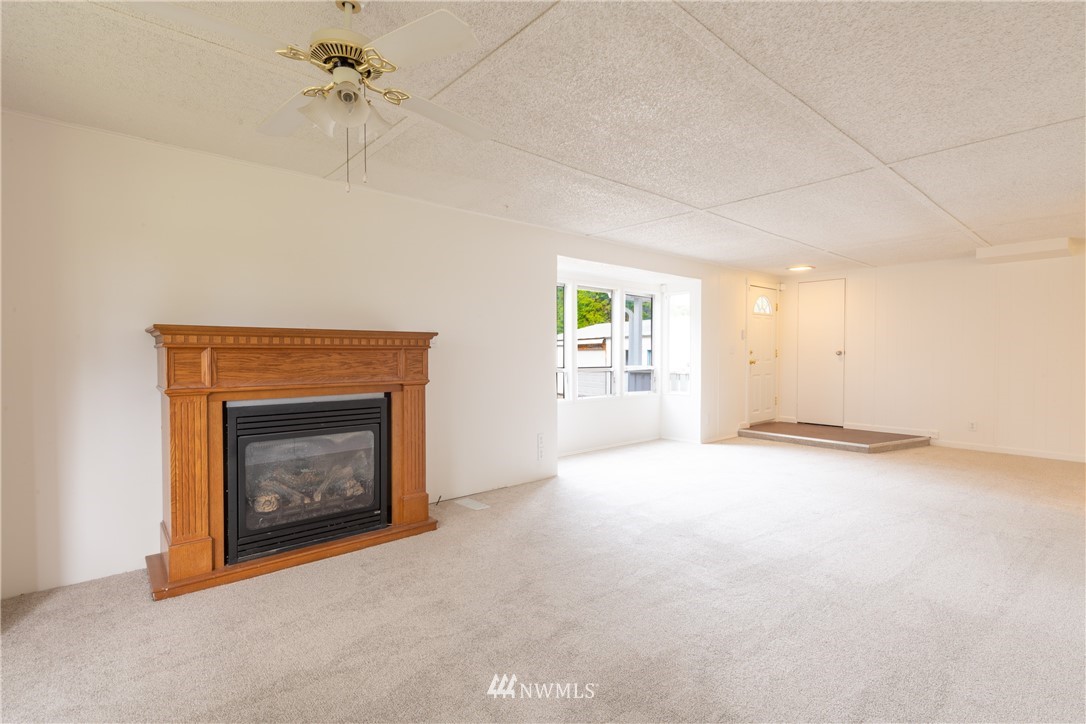 3177 Creasey Road Custer, WA 98240 - Photo 5 of 38 an empty room with windows and fireplace