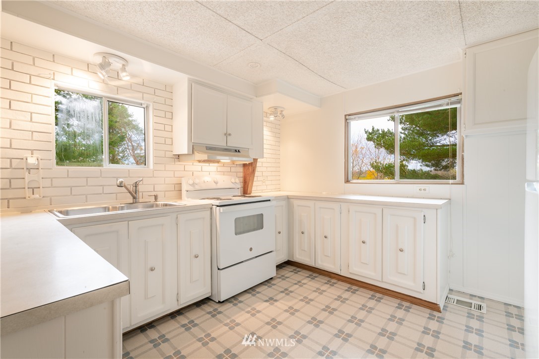 3177 Creasey Road Custer, WA 98240 - Photo 10 of 38 a kitchen with white cabinets a window and a sink