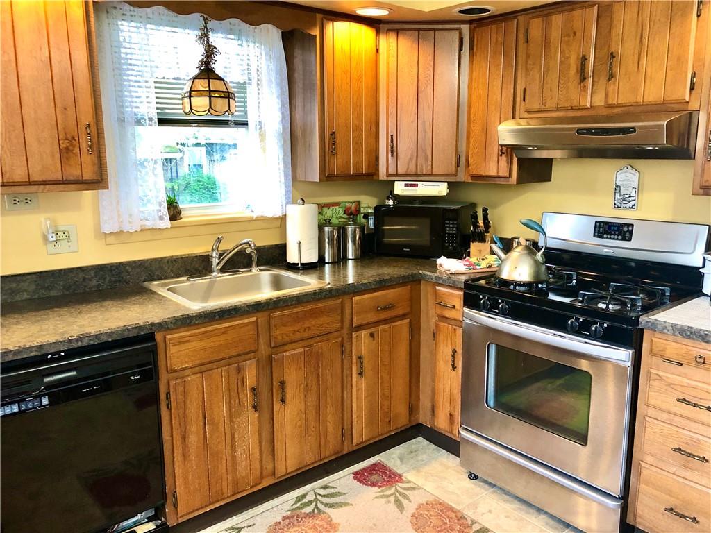 1790 Conway Wallrose Road Freedom, PA 15042 - Photo 4 of 23 a kitchen with stainless steel appliances a stove a sink and a microwave