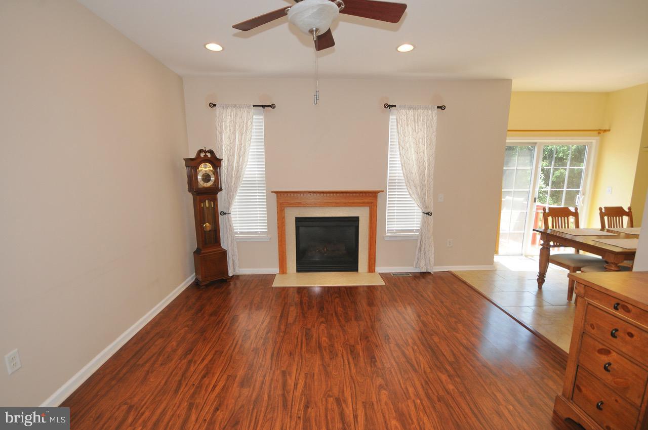 349 Huntington Drive Delran, NJ 08075 - Photo 16 of 68 an empty room with wooden floor fireplace and windows