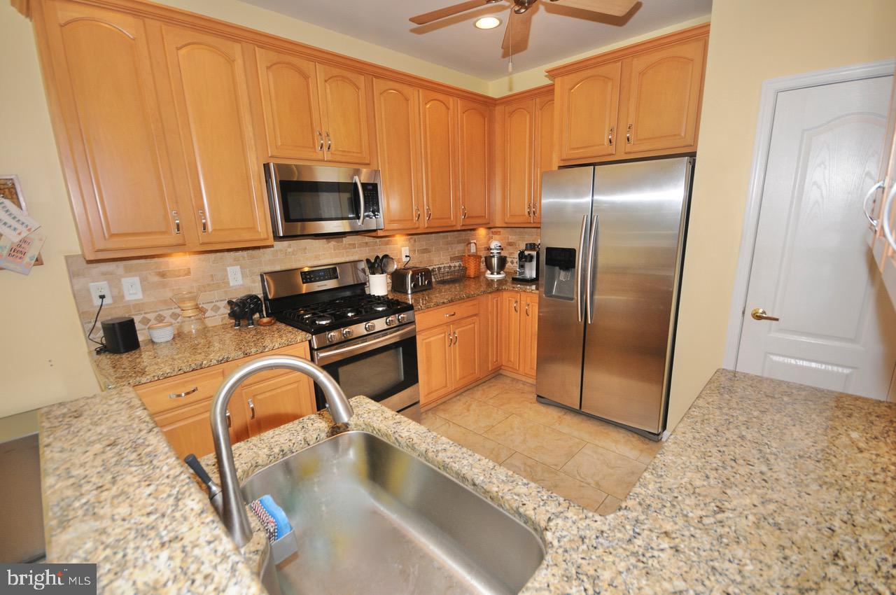 349 Huntington Drive Delran, NJ 08075 - Photo 2 of 68 a kitchen with stainless steel appliances granite countertop a refrigerator a stove top oven a sink and dishwasher