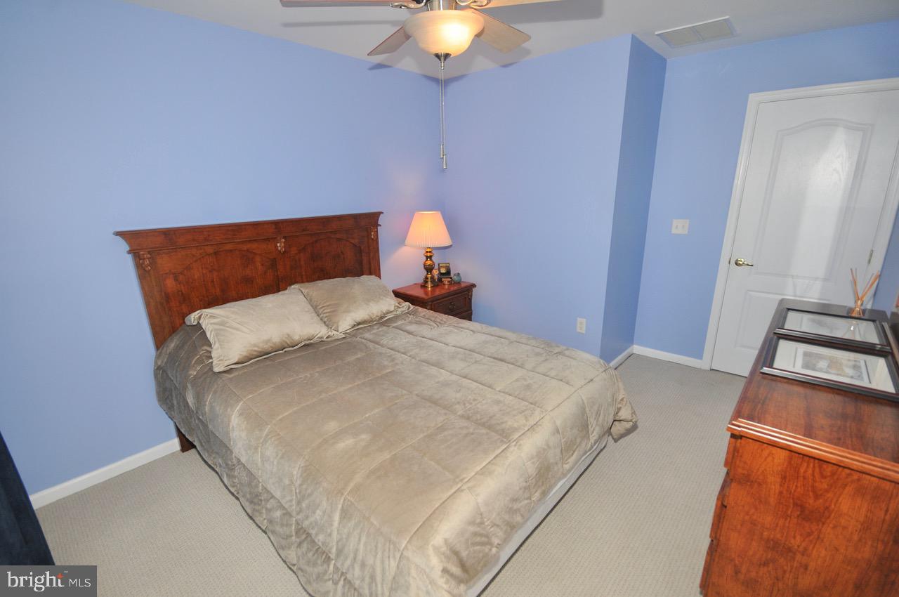 349 Huntington Drive Delran, NJ 08075 - Photo 28 of 68 a bedroom with a bed and a chandelier
