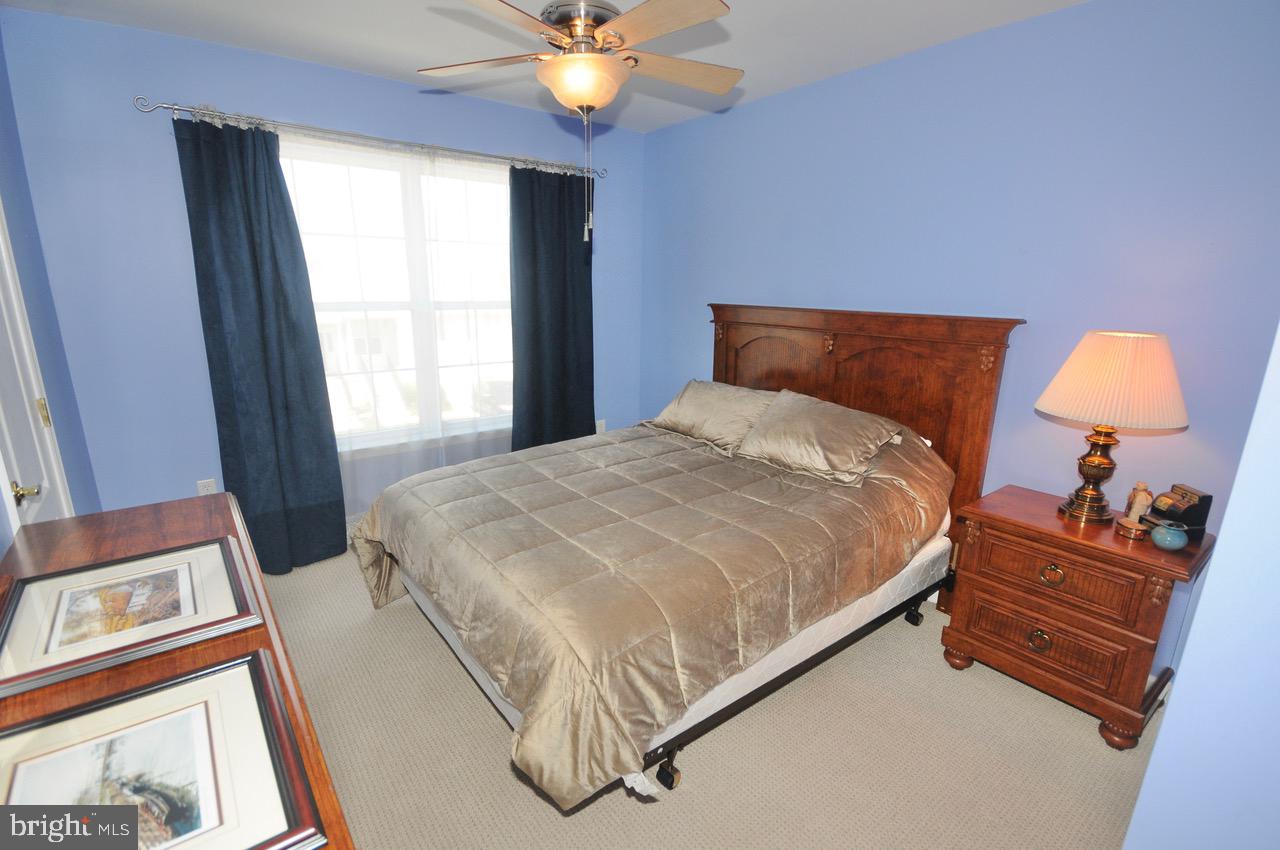 349 Huntington Drive Delran, NJ 08075 - Photo 29 of 68 a bedroom with a bed and a chandelier