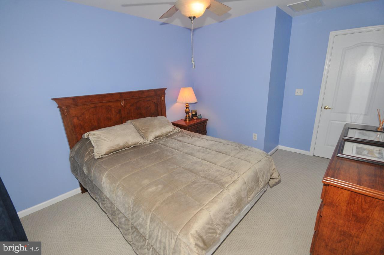 349 Huntington Drive Delran, NJ 08075 - Photo 30 of 68 a bedroom with a bed and a chandelier