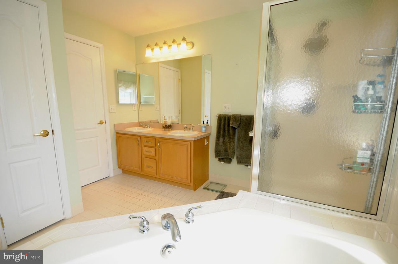 349 Huntington Drive Delran, NJ 08075 - Photo 44 of 68 a bathroom with a tub sink and mirror