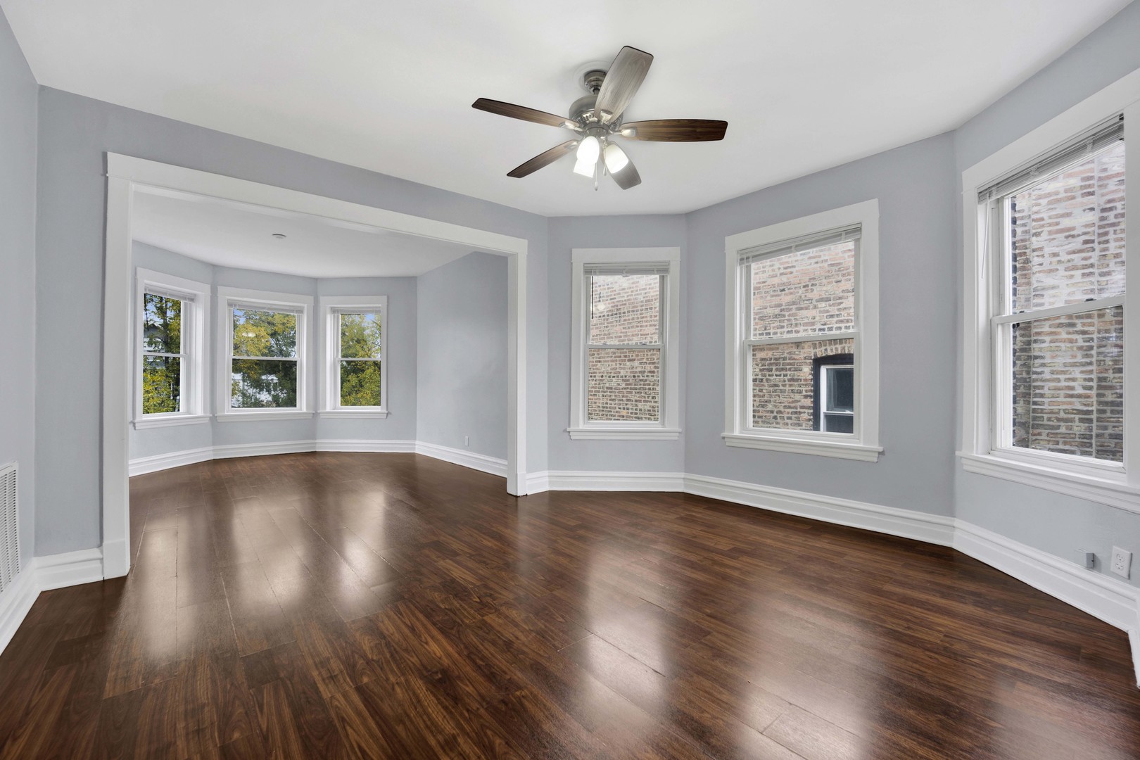 5015 West Montrose Avenue, Unit 2 Chicago, IL 60641 - Photo 11 of 23 a view of an empty room with wooden floor and a window