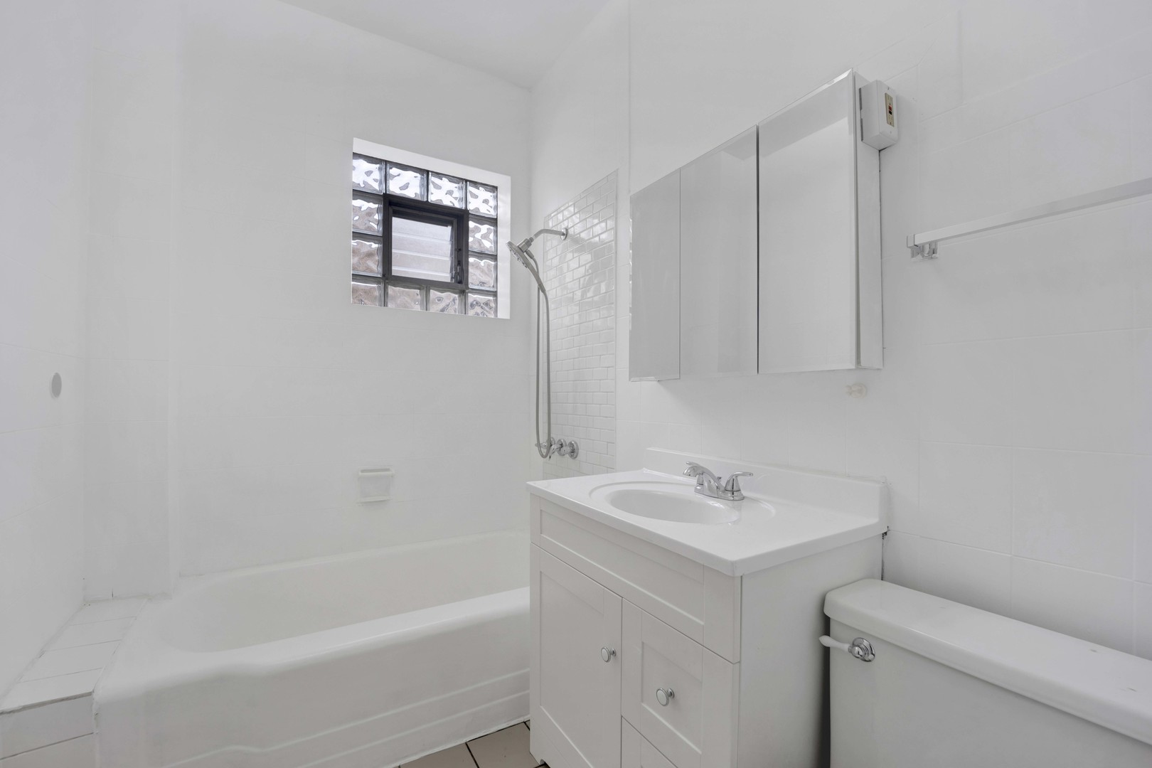 5015 West Montrose Avenue, Unit 2 Chicago, IL 60641 - Photo 14 of 23 a bathroom with a sink toilet and shower
