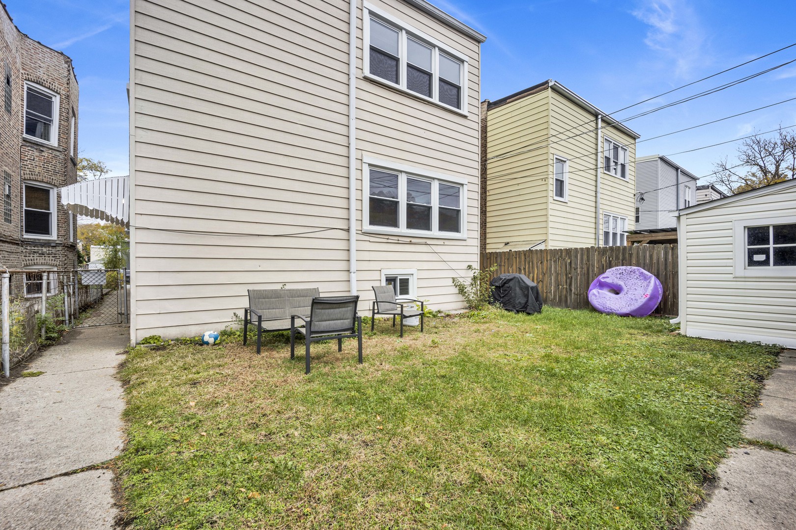 5015 West Montrose Avenue, Unit 2 Chicago, IL 60641 - Photo 21 of 23 a backyard of a house with table and chairs