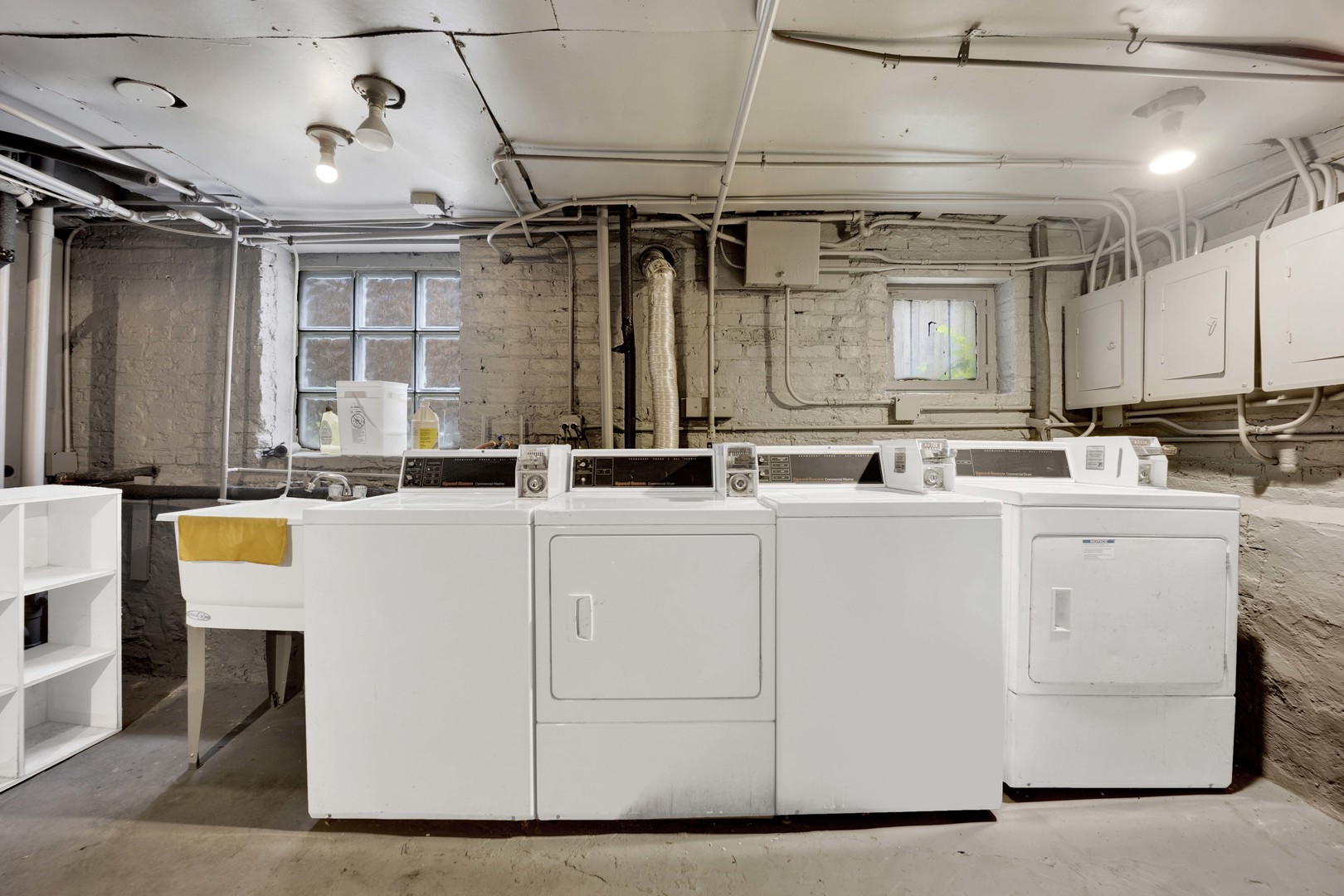 5015 West Montrose Avenue, Unit 2 Chicago, IL 60641 - Photo 23 of 23 a room with kitchen island a white cabinets and sink