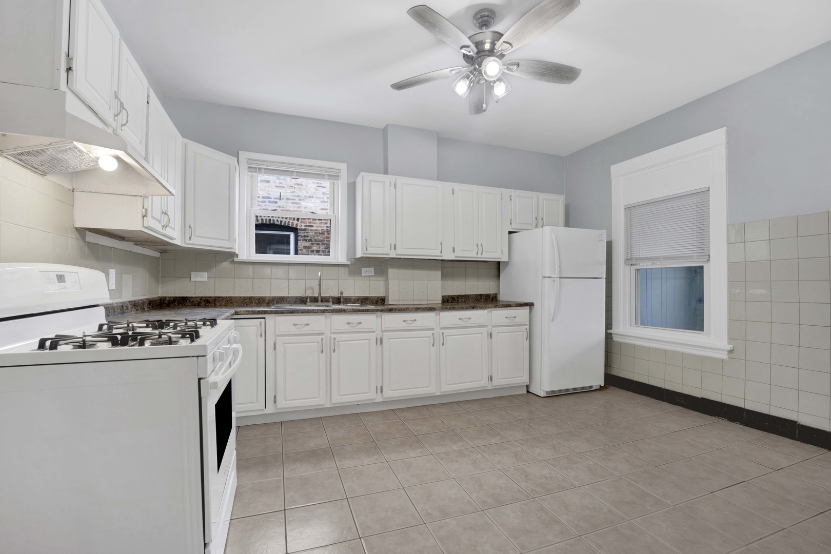 5015 West Montrose Avenue, Unit 2 Chicago, IL 60641 - Photo 5 of 23 a kitchen with refrigerator and cabinets