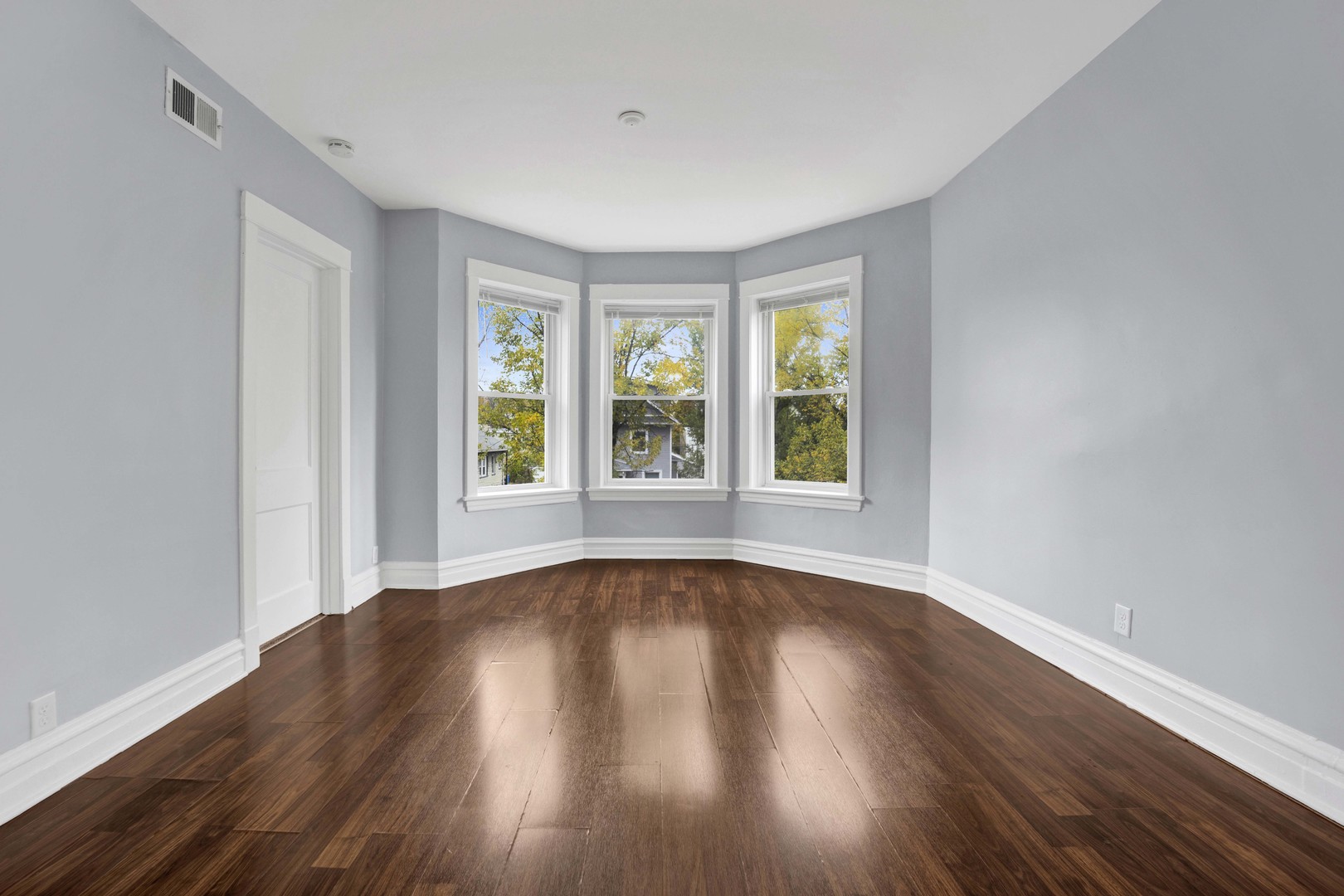 5015 West Montrose Avenue, Unit 2 Chicago, IL 60641 - Photo 6 of 23 a view of an empty room with wooden floor and a window