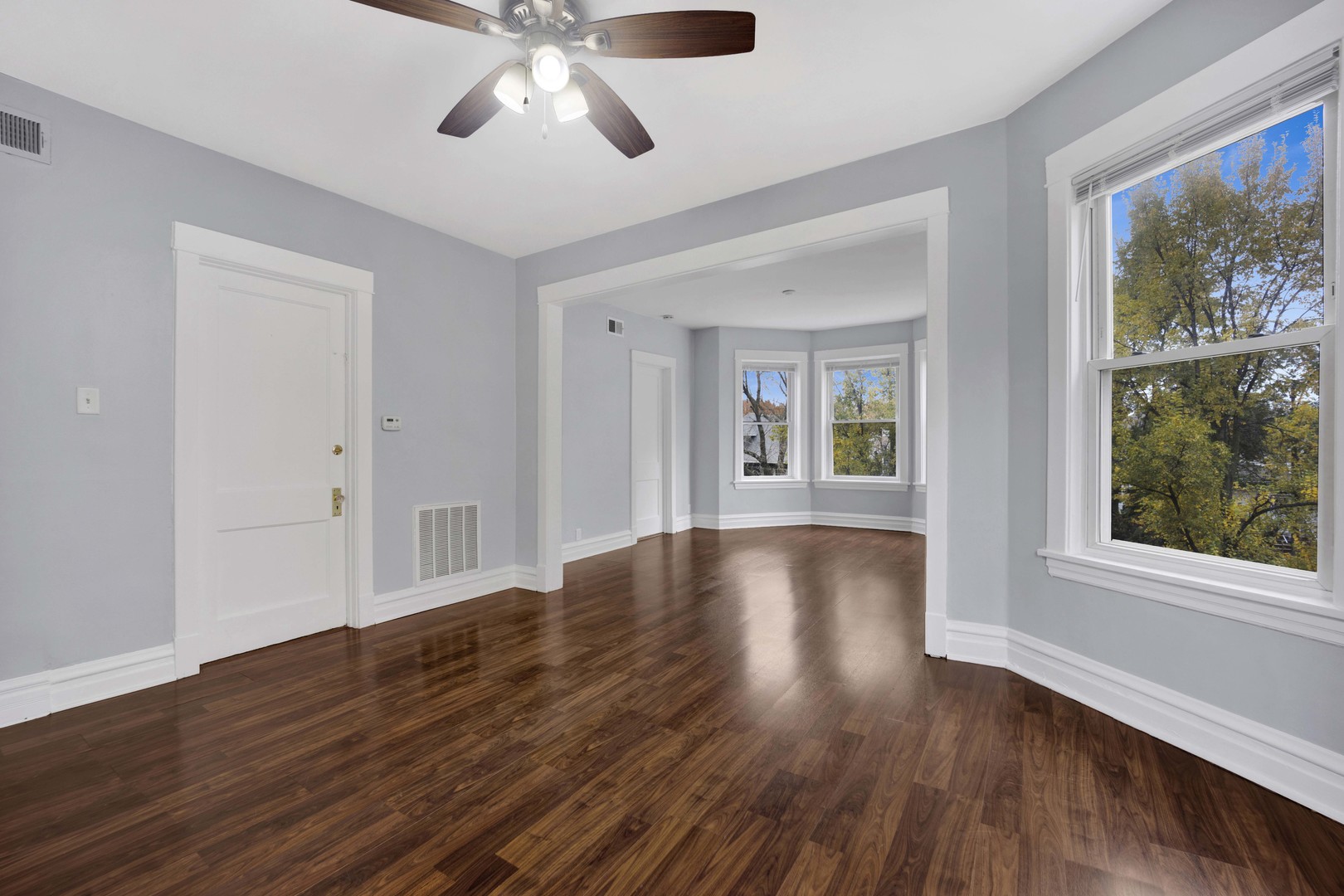5015 West Montrose Avenue, Unit 2 Chicago, IL 60641 - Photo 9 of 23 a view of an empty room with wooden floor and a window