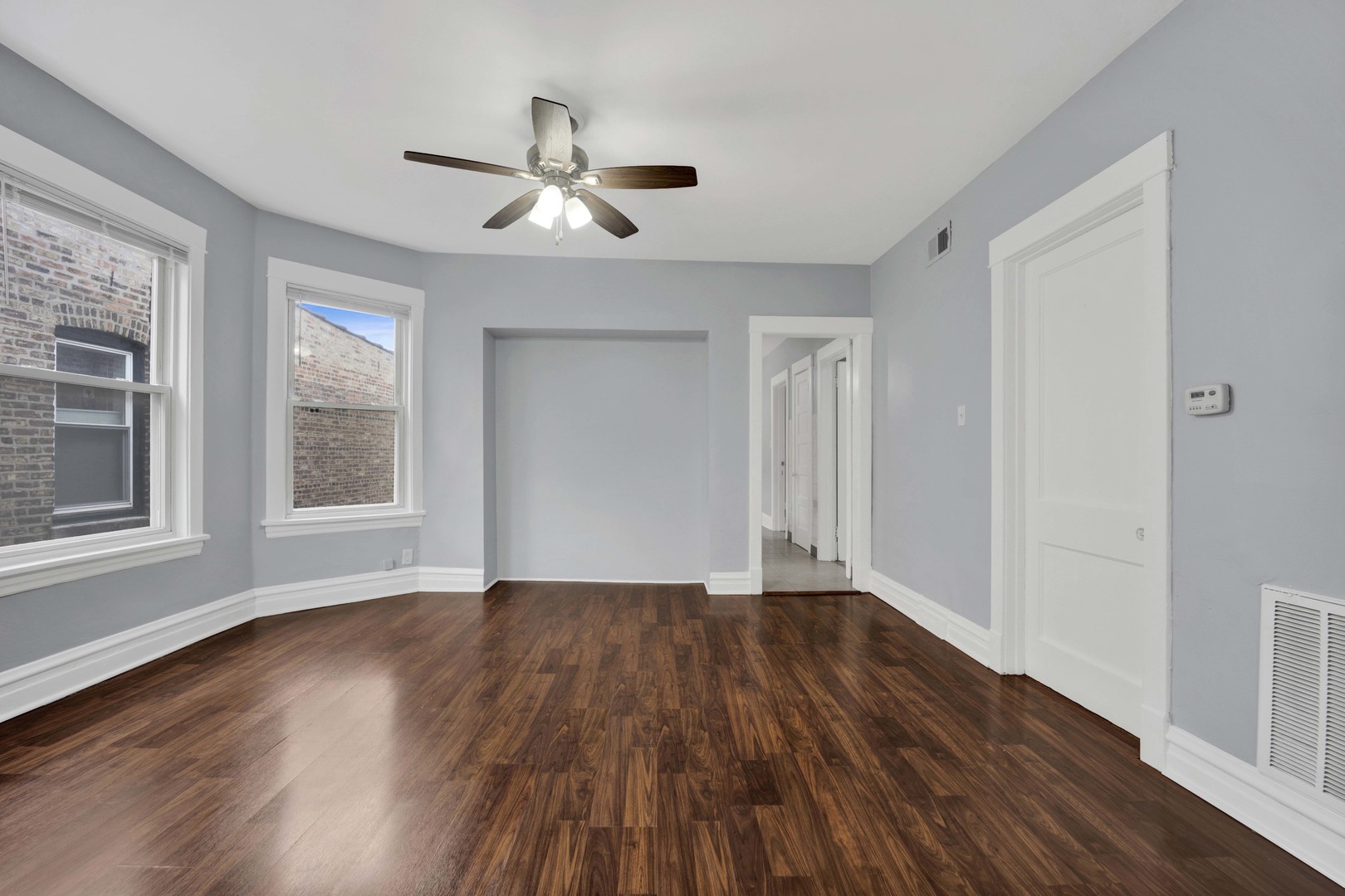 5015 West Montrose Avenue, Unit 2 Chicago, IL 60641 - Photo 10 of 23 a view of an empty room with wooden floor and a window