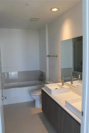 a bathroom with a sink a toilet and bathtub