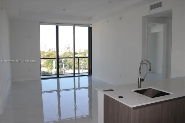 a kitchen with a sink and large window
