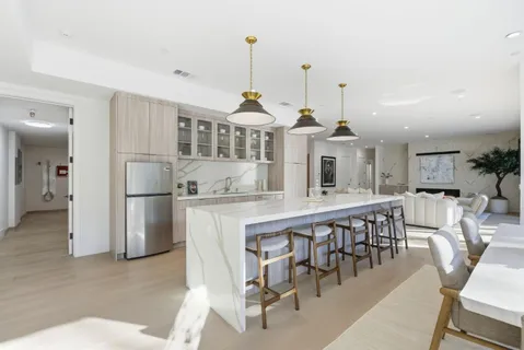 a dining table chairs and a chandelier