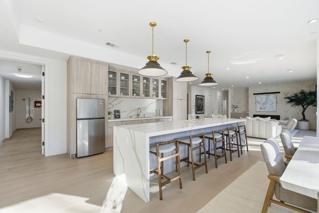 a dining table chairs and a chandelier