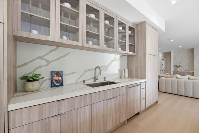 a kitchen with a sink and white cabinets
