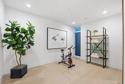 a front view of a building with lots of green space