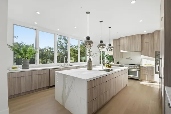 a kitchen with sink stove and refrigerator