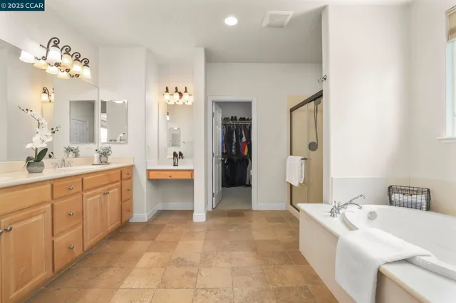 a large bathroom with a sink a large mirror and a bathtub