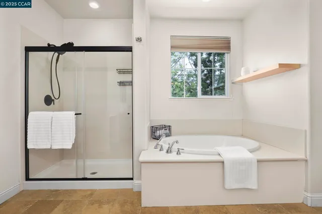a bathroom with a bathtub and a shower