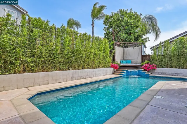 a view of a house with swimming pool and sitting area