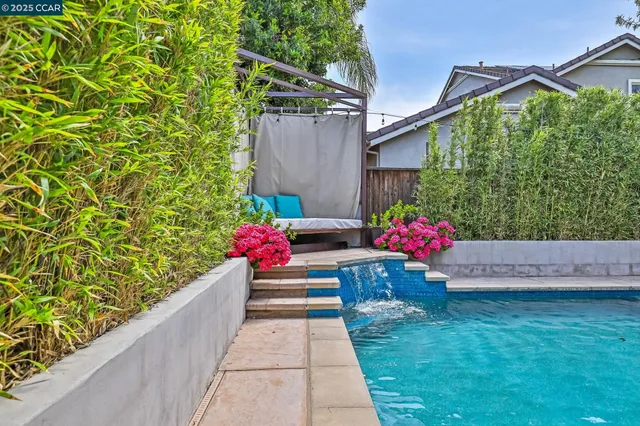 a view of a house with pool and sitting area