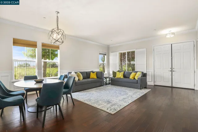 a living room with furniture wooden floor and a table