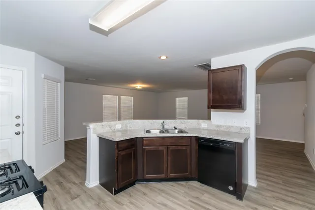 a kitchen with a sink and a stove top oven