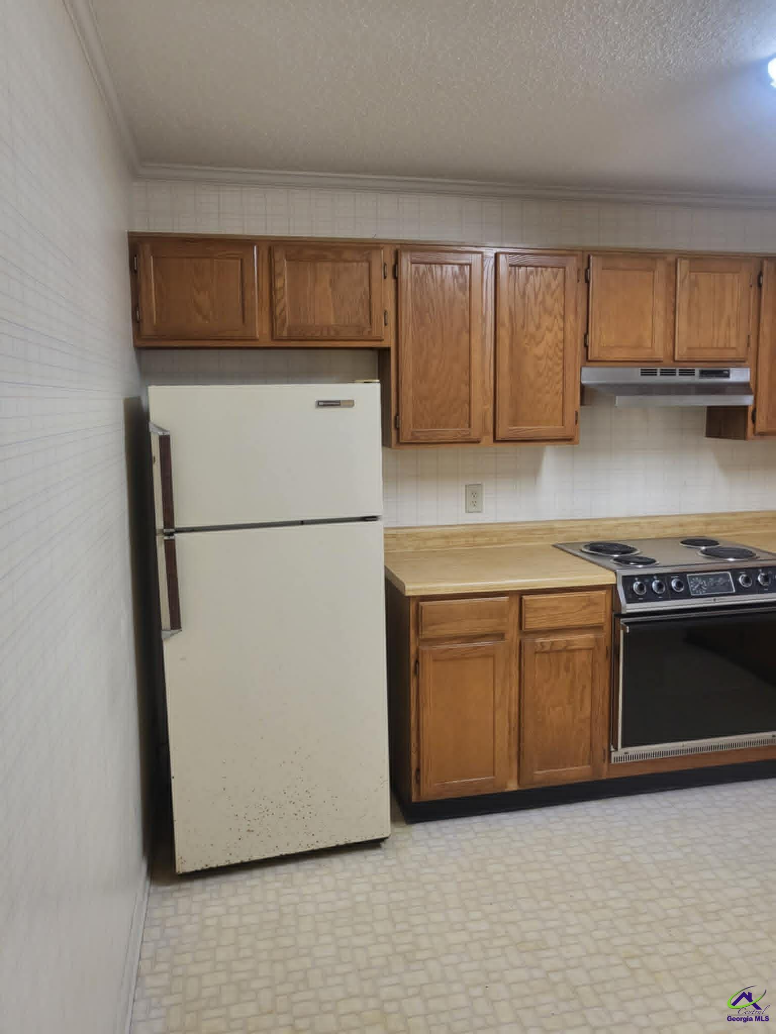 4472 Club Trace Macon, GA 31210 - Photo 5 of 10 a kitchen with a refrigerator and a stove
