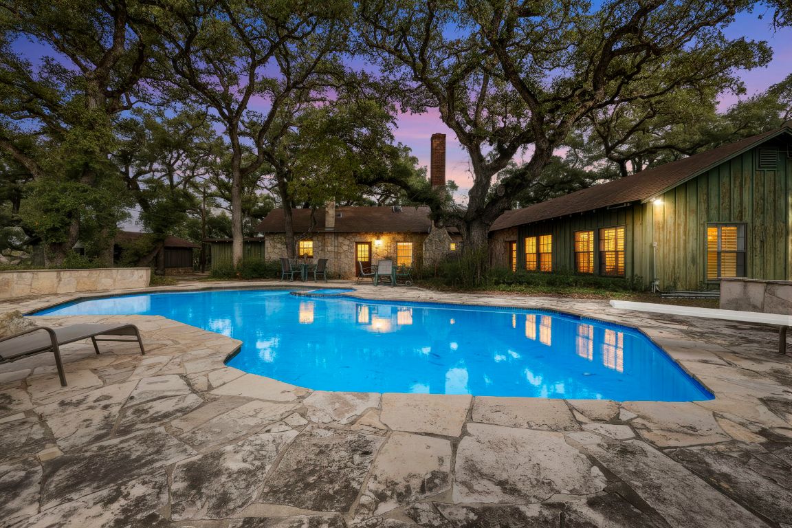 Pool at dusk featuring a patio and an outdoor pool