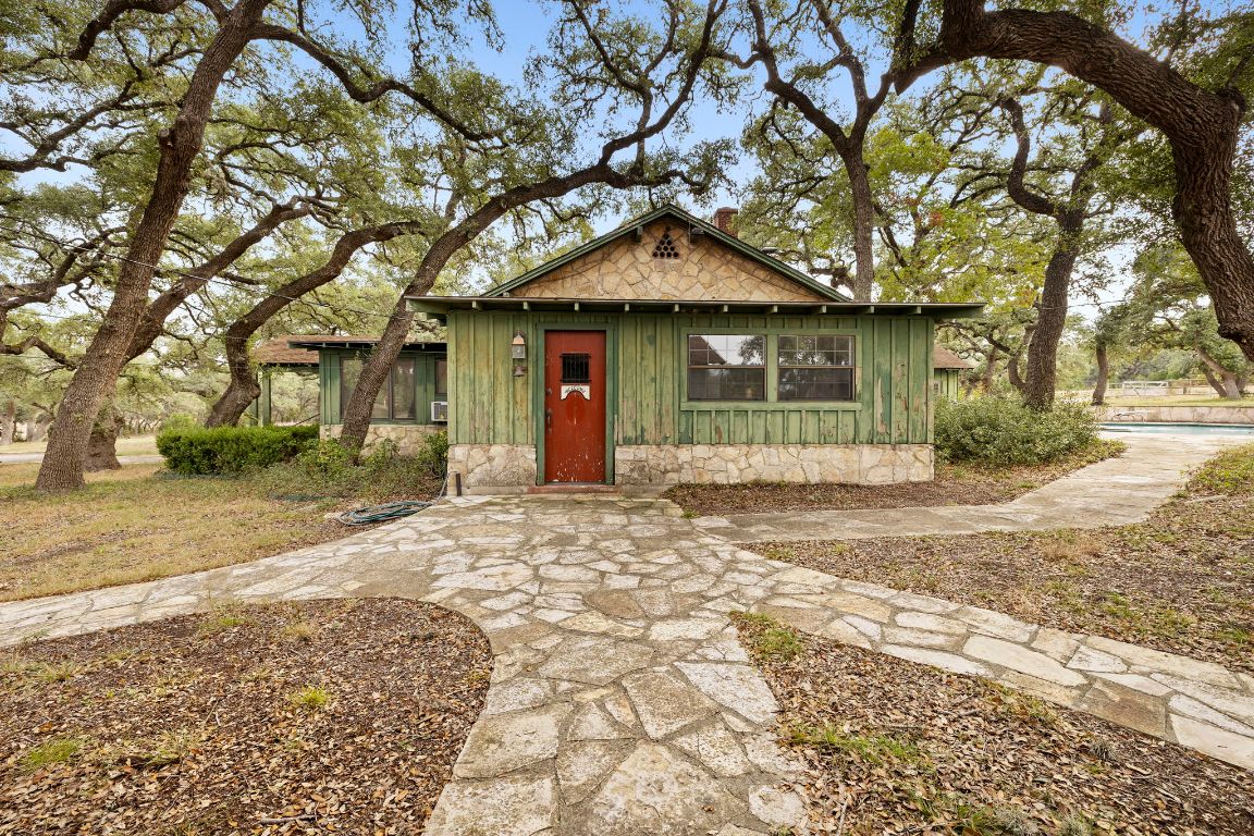 315 Flying R Ranch Road Spring Branch, TX 78070 - Photo 21 of 39 View of front of house with board and batten siding and a chimney