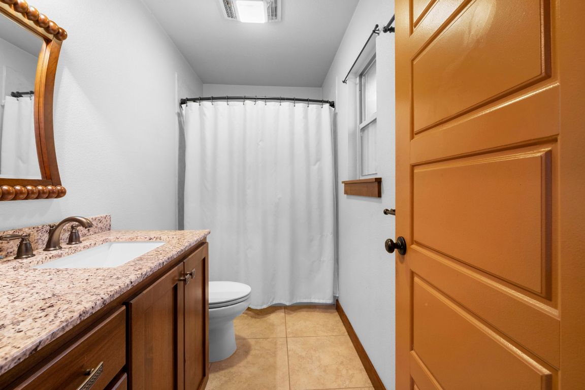 315 Flying R Ranch Road Spring Branch, TX 78070 - Photo 30 of 39 Bathroom with vanity, a shower with curtain, and light tile patterned floors