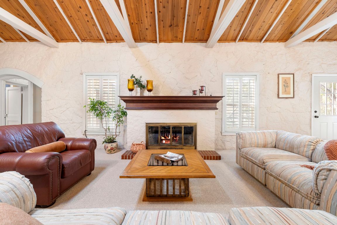 315 Flying R Ranch Road Spring Branch, TX 78070 - Photo 4 of 39 Living room with a glass covered fireplace, wooden ceiling, carpet, and plenty of natural light