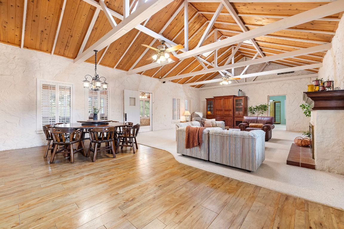 315 Flying R Ranch Road Spring Branch, TX 78070 - Photo 6 of 39 Living area with high vaulted ceiling, light wood-style flooring, a fireplace, a wood ceiling with exposed beams, and a ceiling fan