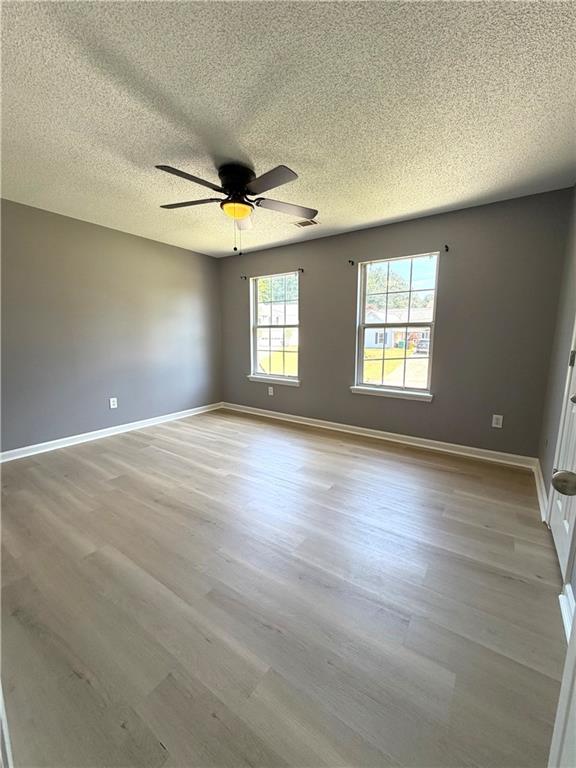 2205 Springer Walk Lawrenceville, GA 30043 - Photo 18 of 26 an empty room with wooden floor and windows
