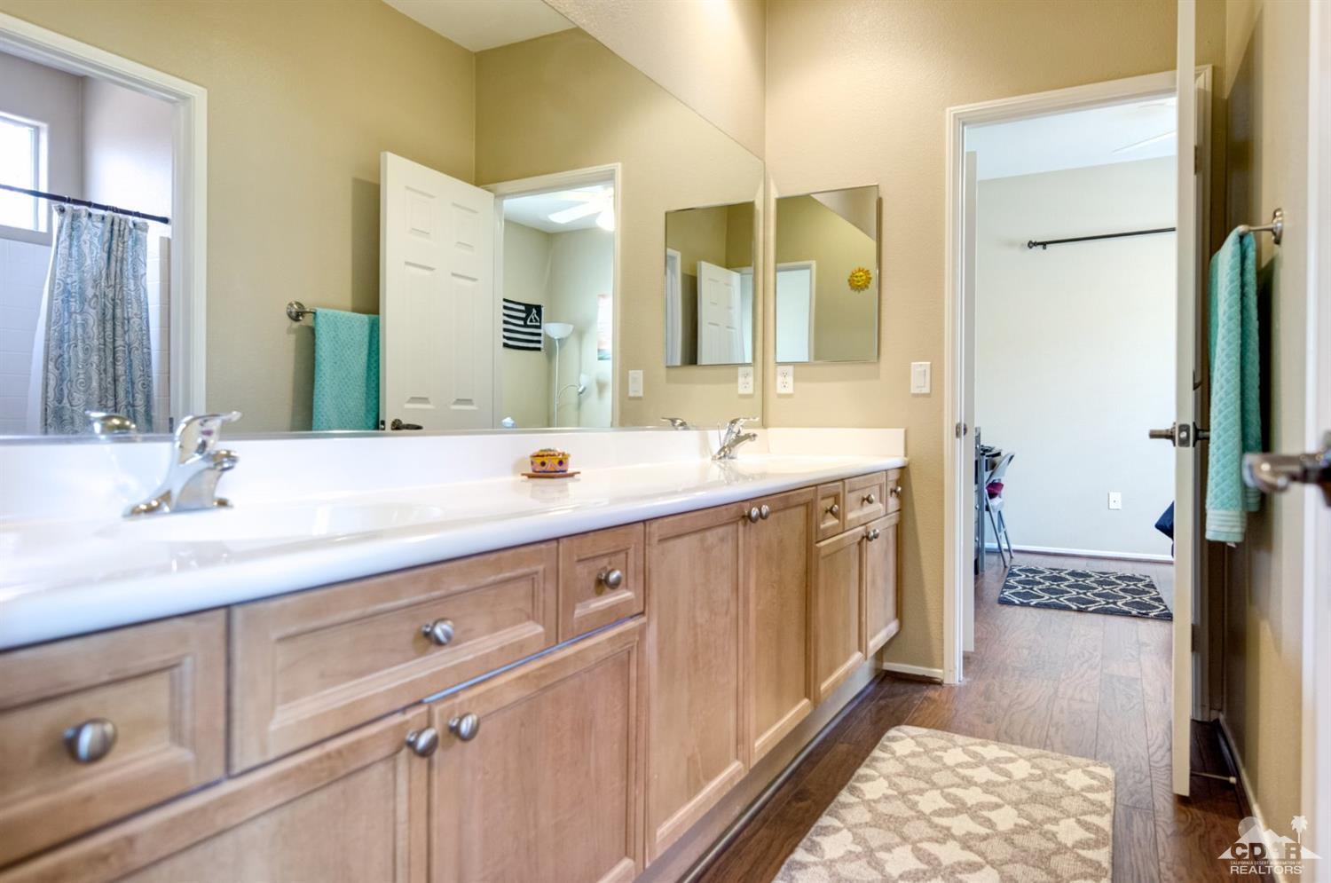 83320 Stagecoach Road Indio, CA 92203 - Photo 22 of 35 a spacious bathroom with a double vanity sink and a mirror